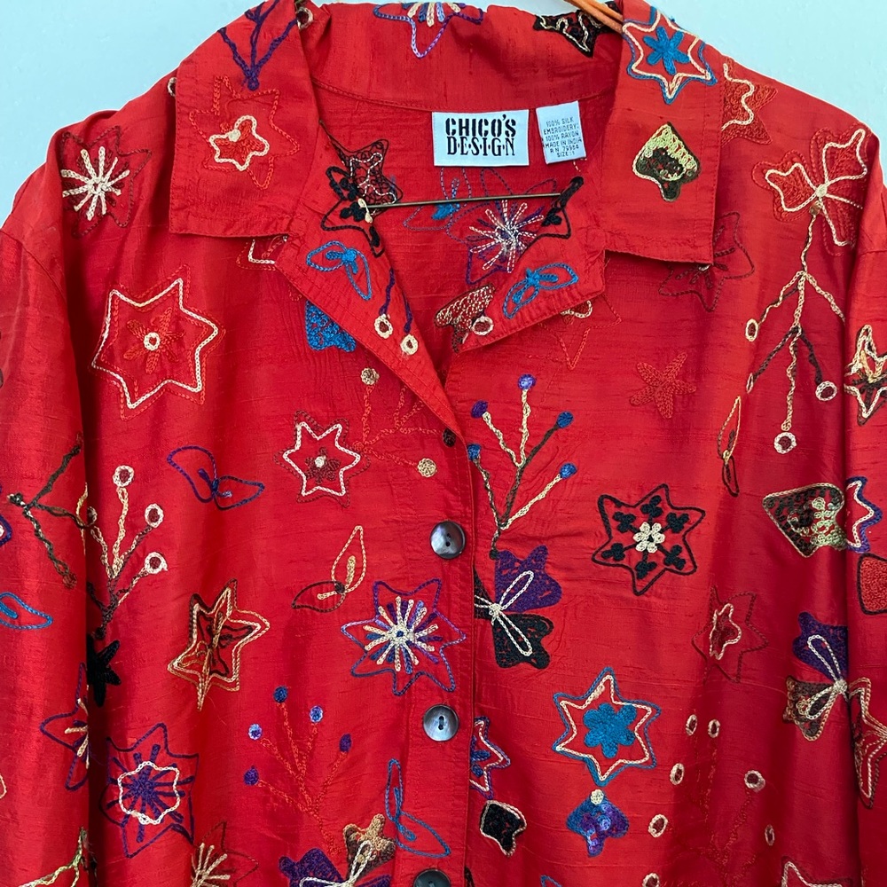 Woman’s long-sleeved silk embroidered blouse by Chico’s Design.